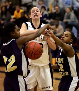 Shareese Ulis, left, and Lakina Cleveland knock the ball away from Notre Dame's Kristen Kerscher. Ulis led Waite with 17 points and Cleveland just missed a game-winning shot.