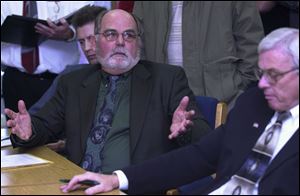 Dan Liskai, center, makes a point as fellow commissioners Brad Smith, left, and Terry Thatcher look on during their hearing in Sandusky County Juvenile and Probate Court. Mr. Liskai appealed for time to find an attorney to defend them.