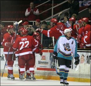 The Storm celebrates a goal by Nick Parillo as Atlantic City s Dan Peters skates away.
