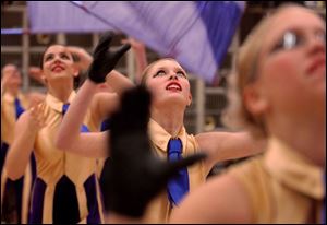 NBR drump05  Maumee winter guard Emily Burghardt practices with her flag team before competing on saturday afternoon at Waseon high school. the  The Blade/Kevin Nortz