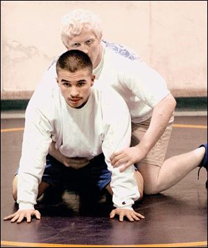 Kevin Roper, top, works out with teammate Angelo Castillo in the wrestling room at Waite. Roper has a 9-8 record and fi nished fi fth in the City League meet at 171 pounds.
