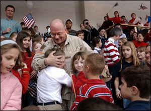 Sgt. Jeff Gagle, elementary principal at Toledo Christian School, is greeted by his students during a welcome-home ceremony.
