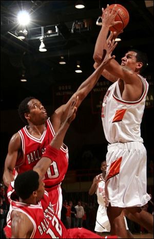 BG's Josh Almanson rises over two Ball State defenders. 
Almanson scored 20 points and grabbed seven rebounds.