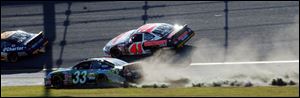Tony Stewart drives across the grassy area of the infield before getting back on the track and eventually on to victory.
