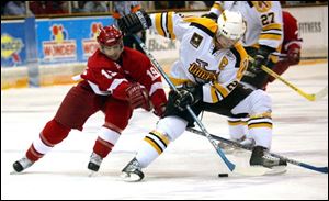 The Storm's Todd Jackson, left, battles with Jean Desroches of Johnstown for the puck at the Sports Arena last night.