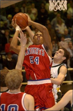St. Francis' Marlon Price elevates
above the Clay defense to score two of his 10 points last night at Libbey.