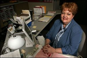 Jeannette Crone, secretary at Port Clinton High School since 1975, makes a point to welcome visitors with a smile. 