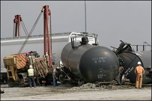 CTY derail09p  Workers clean-up derailed railroad cars at the north end of the CSX Stanley Yard at Walbridge Road, between Tracy Road and East Broadway, in Lake Township on Wednesday, 3/9/05. The Blade Dave Zapotosky