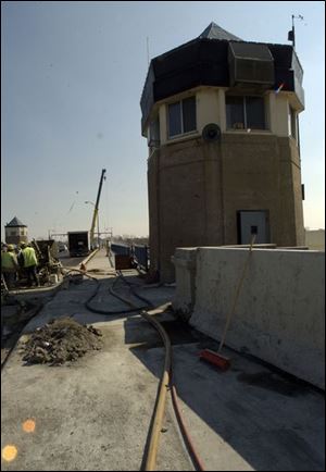 Construction crews work one of the control towers on the Martin Luther King, Jr., Bridge.
