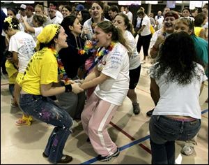 Suzie Sobieski, left, and Kate Lynch join more than 200 classmates for the 10th annual fund-raiser.