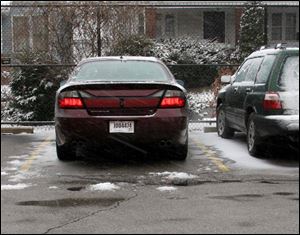 A Pontiac Bonneville driven by Executive Director William Dennler is parked in the administration lot at the Toledo Zoo. 
