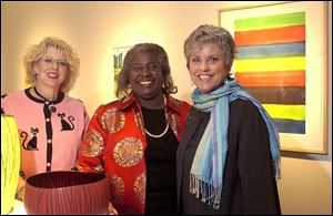 From left, Marlene Uhler, Deanna Johnson, and Paula Brown enjoy the art museum docents  annual winter party Saturday.
