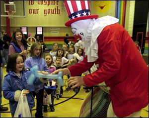 NBR fun18p  Indian Hill Elementary School held a fun night at the Rossford, Ohio school on March 18, 2005. Carly (cq) Hollerbach, 7, left, gets a dog made of balloons from Quacky the Clown  at the event. The Blade/Jetta Fraser
