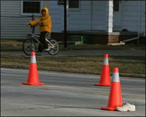 Evidence cones and a shoe worn by 5-year-old Dameatrius McCreary mark the area where the Oregon boy was hit by a car.
