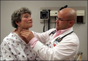 Medical student Jacob Bieszczad examines 'patient' Louise Dishong during a session at Medical College of Ohio. The program aims to help train medical students in a variety of situations.