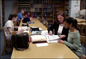 Libbey McKnight, left, offers Gabrielle Hill, a Rogers High School junior, advice on colleges.