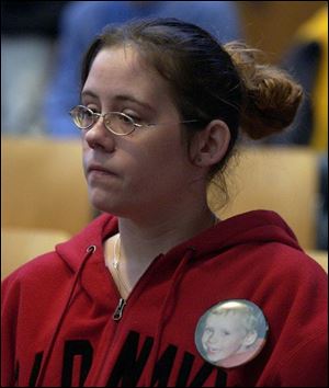 Dameatrius s mother, Sandra TenEyck, wears a picture
of her son at the hearing.