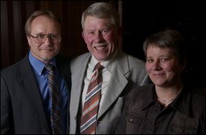 Jim Barnes, left, a councilman filling in as mayor of Pemberville, and Wilhelm and Karin Neidermeier, of Germany, gather for the 10th anniversary of the friendship agreement.

