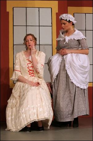 Constance Partley, left, played by Kelly Barkhimer, and the
character s mother, Mrs. Partley, played by Kristen Heller, rehearse
a scene from The Sorcerer in Bowling Green.
