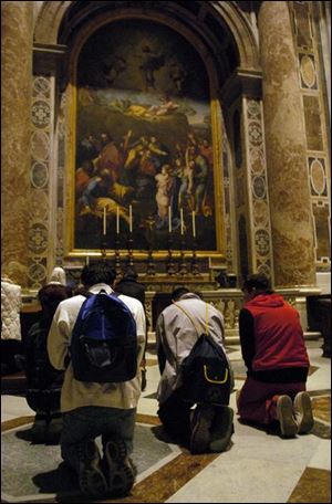 Mourners pray inside St. Peter's Basilica.
