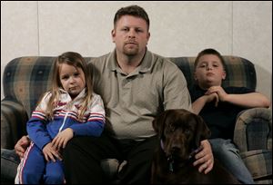 Andrew Purtee says he thinks the charges are fair but don't solve the loss. With him are daughter Sydney, 5, son Drew, 8, and their pet, Brooke, who survived the attack.
