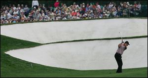 Chris DiMarco hits to the fifth hole during third-round play. DiMarco leads at 13-under par.
