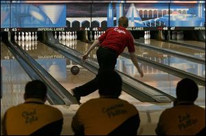 T.J. Eagle of St. Francis bowls at Imperial Lanes as members of Clay s team watch. In Ohio, 153
schools have boys bowling teams and 146 have girls teams.
