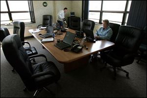Hiram Crabtree, ODOT network administrator, and Kelli Burkhardt, business administrator,
work in the dual-use conference room and emergency operation center at an $8,800 table.