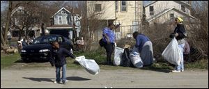 Tyjene Hunter, 11, swings her bag while her mom, Charmaine Hunter, far right, watches. 