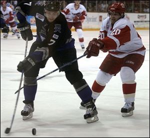 The Storm's Rick Judson fights for the puck with Reading's Reagan Rome.