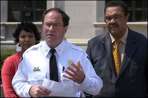 Flanked by Councilman Karyn McConnell-Hancock and Mayor Jack Ford, Chief Michael Navarre
says that paying to extradite more suspects may be costly but is  the right thing to do. 
