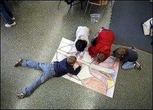 Troy Cornett, 8, left, Sabrina Khuder, 6, Ross Yarger, 9, and Sam Breece, 7, work on their nature mural. 
