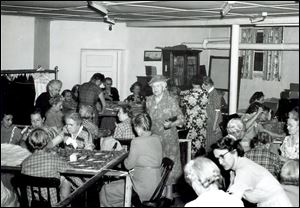 Women from First Mennonite Church in Bluffton quilt for their denomination s relief efforts in this 1940s-era photo, when the focus was on refugees in Europe. Scenes such as this were typical in church basements and in Mennonite homes.