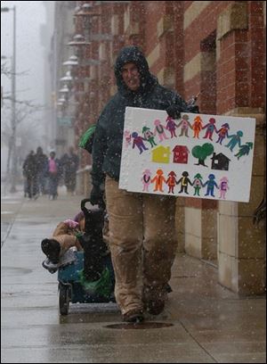 CTY march24p Jenn Eschedor pulls Mauda Morris, 4, through downtown Toledo during the March of Dimes walk, April 24, 2005. Jenn was walking for fetal alcohol spectrum disorder awareness. Morris was born with health problems due to alcohol consumed by her birth mother. The Blade/Lori King
