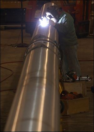 Fru-Con Construction employee Dave Digby works on a stainless steel cable sheathing.
