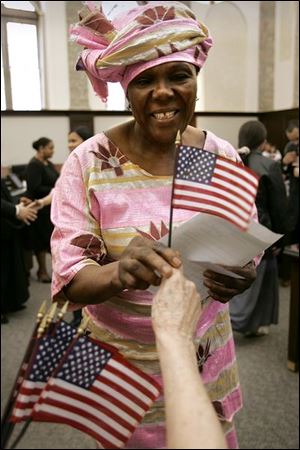 Catherine Chea wears a traditional Liberian outfit at the federal court ceremony, where 37 people became U.S. citizens.