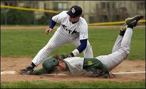 Jay Wheeler's tag is a shade too late as Start's Jacob Koechley dives back to third base in the third inning yesterday. Koechley got up and later scored on Mike Nyitrai's three-run double.