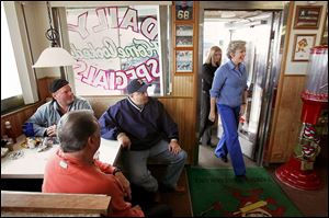 Gov. Jennifer Granholm enters Bobby's Kitchen on South Dixie Highway, surprising early morning diners. She was joined by Democratic state Reps. Herb Kehrl and Kathy Angerer.