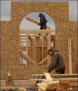 BIZ build01p 1 Lett Construction framers Russ Lett, owner, on ground, and Denny Moore frame one of Crystal Ridge Villas off Monclova Rd., April 27, 2005. The Blade/Lori King