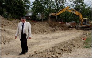 G. Michael Pratt, who heads the archaeological team hired by the county, walks through the grounds, where an upscale housing development is planned and where graves continue to be discovered. Mr. Pratt says the discovery of long-forgotten cemeteries is not that unusual.