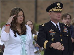 Widow Tiphany Eckert and Brig. Gen. Michael Beasley salute the coffin of Sgt. Andy Eckert following his funeral yesterday. 