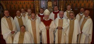 Toledo Catholic Diocese priests with 40 years or more in the priesthood include, from left, the Rev. Robert Weithman, the Rev. Roger Bonifas, the Rev. Joseph O Brien (seated), the Rev. Richard Dunn, the Rev. Benedict Ringholz, the Rev. Michael Ricker, the Rev. Stephen Stanbery, Bishop Leonard Blair, the Rev. Dennis Hartigan, the Rev. Paul Kwiatkowski, the Rev. Nick Weibl, the Rev. Thomas Leyland, the Rev. Frederick Duschl, and the Rev. Martin Donnelly.

