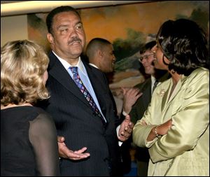 Mary Chris Skeldon, left, and Deborah Barnett help Jack Ford celebrate his birthday at a re-election fund-raiser.