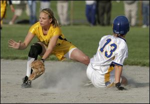 St. Ursula s Chelsey Jones is safe at second as Notre Dame s Alison Trojan waits for the throw. Jones scored the tying run.