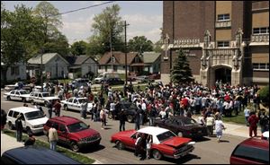 Worried parents wait for their children to be dismissed from Riverside School Wednesday, after reports of a gun being found in the building. 