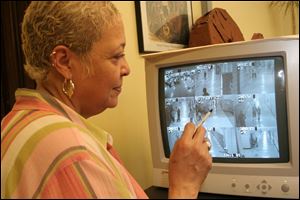 Pamela King, principal of Jones Junior High School, views nine images at once, each from a different camera. She says her students behave better knowing that their actions are observed.