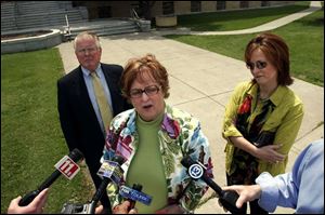 Lucas County Republican leader Sally Perz, flanked by lawyer Barry Savage and daughter Allison
Perz, makes a statement after her grand jury testimony.