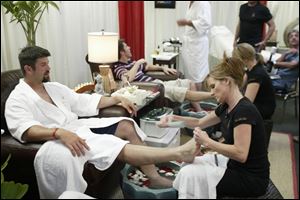 Catcher Jason Varitek, who was flown in by helicopter for the event, receives a treatment.