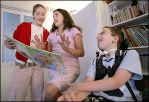 Kylie Keller, left, and Allie Smith are just two of the 16 Bowling Green students who have
stopped by Bryce Christensen s house to read and sing to the 11-year-old.
