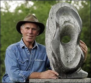 James Havens with 'Moonlit Blossom,' by Emmanuel Enriquez, is the force behind the Williams Park exhibition. 